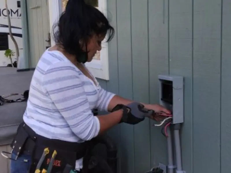 Licensed electrician wiring an exterior subpanel in Green Oak
